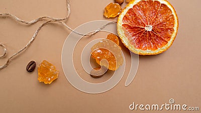 Citrus and spicy background with coffee beans and spices, warm ochre background. Stock Photo