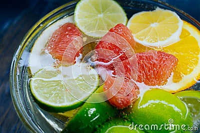 Citrus in water with bubbles in transparent plate Oranges, lemon Stock Photo