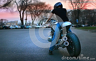 City biker rides his motorcycle Stock Photo