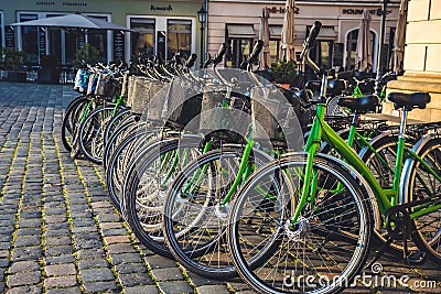 City bikes rent in big city. Ekological transport. Share-use bicycles in a city centre. Editorial Stock Photo