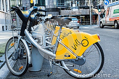 City of Brussels Belgium - Villo station with a row of yellow cycles for sharing and renting in the city Editorial Stock Photo