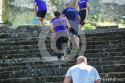 City Cesis, Latvian Republic. Run race, people were engaged in sports activities. Overcoming various obstacles and running. July Editorial Stock Photo