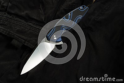 City clothes and pocket knife. Men`s pants and a knife Stock Photo