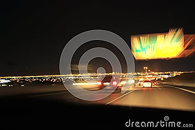 City colorful night lights perspective blurred by high speed of the car. A streak of light, trails in USA Stock Photo