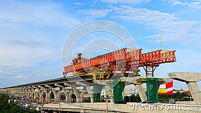 City expressway under construction with huge modern mechanical equipment. Big heavy machine crane on giant pillars during express Stock Photo