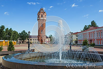 City fountain against the background of an water tower. Staraya Russa Stock Photo