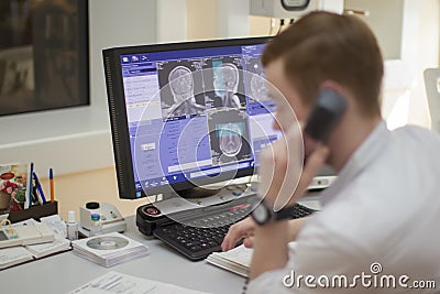 The doctor makes magnetic resonance therapy. Editorial Stock Photo