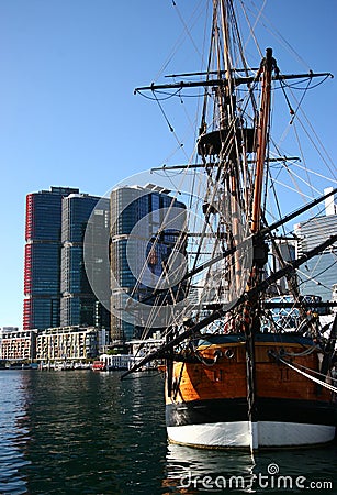 Moored historic sailing ship with iconic cityscape of modern skyscrapers on harbor waterfront, Darling Harbour, Sydney, Australia Editorial Stock Photo