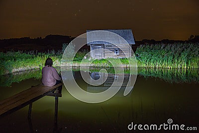 Bath house at night, stars and man. Water and grass. Travel photo 2018. Editorial Stock Photo