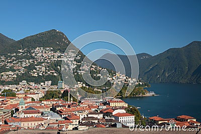 City and lake in mountains. Lugano, Switzerland Stock Photo
