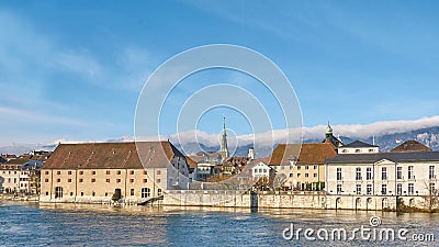 City landscape with a small town in Switzerland and mountains in the background. Stock Photo