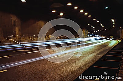 city lights long exposure street life in the city cars speed in a tunnel Stock Photo