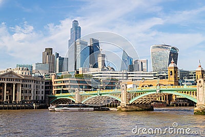 City of London and an Uber Boat on the River Thames in London Editorial Stock Photo