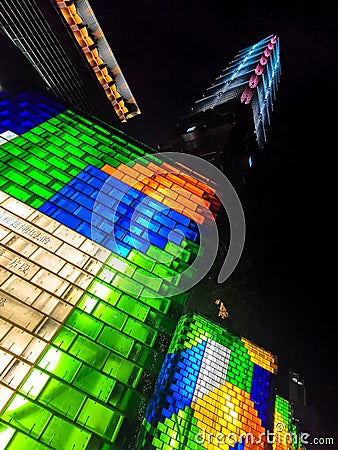 City of neon brick looking lights in yellow orange blue green white in downtown Taipei Taiwan Editorial Stock Photo