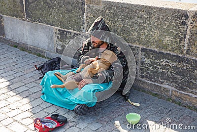 City Prague, Czech Republic. On the street the beggar with dog treats people for money. 2019. 24. April Editorial Stock Photo