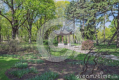 City Riga, Latvia Republic. City park with china gazebo. Trees and nature. May 7. 2019 Travel photo Editorial Stock Photo