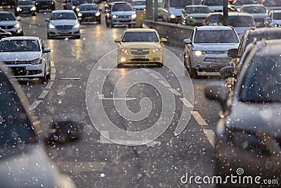 City road with moton cars and snow Stock Photo