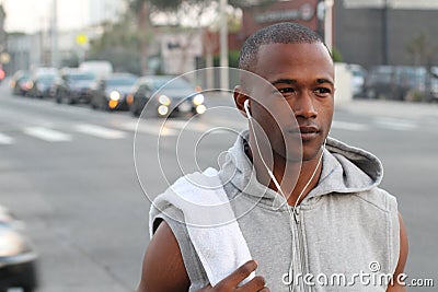 City runner - urban new yorker African American male running in busy street in New York NYC. Young black adult jogging in traffic Stock Photo