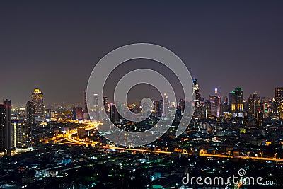 City scape of skyscrapers with lights on in the offices by night Stock Photo