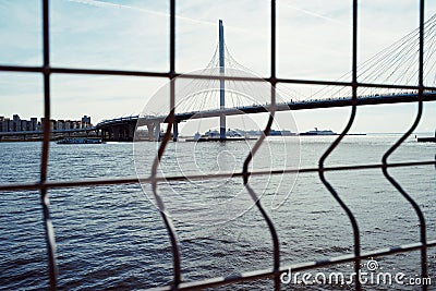 city sea blue water bridge sunlight day metal fence Editorial Stock Photo