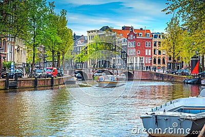 City skyline with water canal and tourist boats, Amsterdam, Netherlands Stock Photo