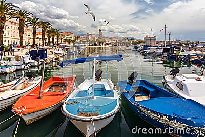 City of Split with colorful fishing boats in harbor, Dalmatia, Croatia. Waterfront view of fishing boats at mediterranean scenery Stock Photo