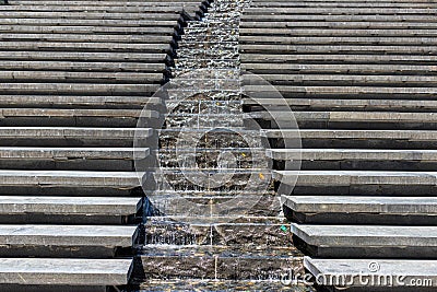 City stream. Water cascade. Steps down and in the middle, water flows down the steps. Modern designer steps Stock Photo