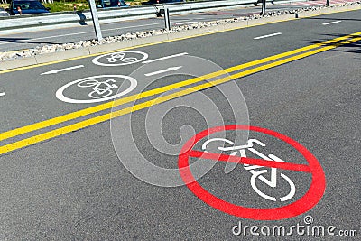 City street asphalt road with separated two way direction bicycle lane route sign mark and bike riding prohibited symbol Stock Photo