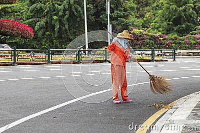 City street cleaners in special clothes with panicles and straw hats Editorial Stock Photo