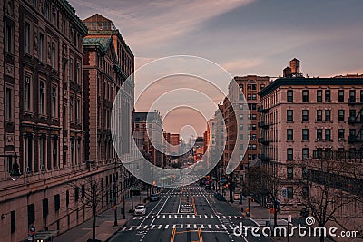 A city street with tall buildings at sunset - Amsterdam Avenue from Columbia University, in Morningside Heights, New York City Editorial Stock Photo