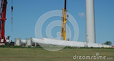 2 cranes with 2 rotor blades for a wind turbine are ready for installation, 2010 Stock Photo