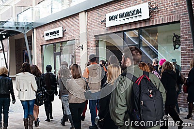 City tour, people walk and look at shop windows Editorial Stock Photo