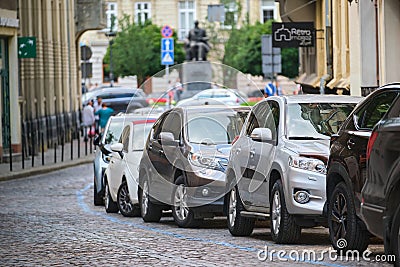 City traffic with cars parked in line on street side Editorial Stock Photo