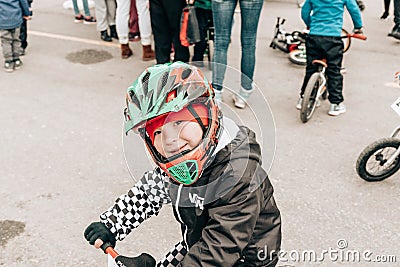 City Tula. Russia - April 06, 2019: little boy in a protective helmet on amateur competition of children to balance bicycle Editorial Stock Photo