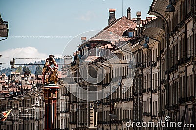 City view of Bern Switzerland with houses and the statue of Samson and the lion on the left Editorial Stock Photo