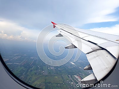 City view clouds and sky as seen through window of an aircraft. Stock Photo