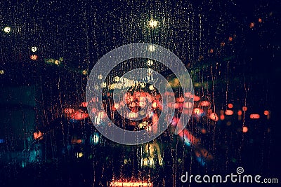 City view through a window on a rainy night Stock Photo