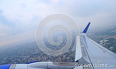City and Wing of the Aircraft from Window - Aviation Industry and Travel in Flight Stock Photo