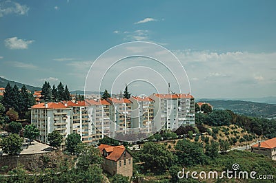 Cityscape with apartment building in the midst of trees Stock Photo