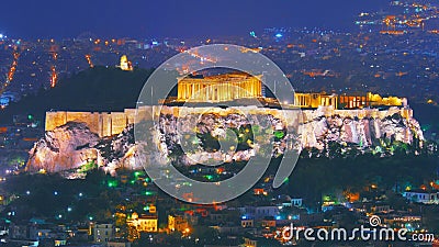 Cityscape of Athens with illuminated Acropolis hill, Pathenon and Herodium construction and sea at night. Athens skyline at night Stock Photo