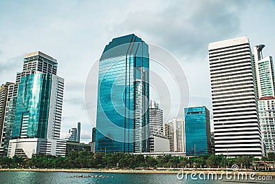 Cityscape of Benchakitti park with lake view and skyscrapers during daytime. Bangkok Editorial Stock Photo