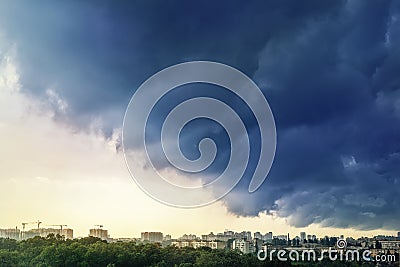 Cityscape covered with dramatic stormy dark clouds before heavy rain and thunderstorm. Natural disaster. Autumn seasonal Stock Photo