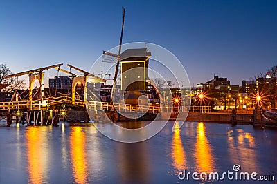 Cityscape - evening view of the city canal with drawbridge and windmill, the city of Leiden Stock Photo