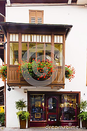 Cityscape of Façade and flowers on balcony, in Cortina dAmpezzo, Province of Belluno, Italy Stock Photo