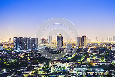 Cityscape from high rise building at night with skyline and clouds. skyscraper in metropolis town with beautiful neon light Stock Photo