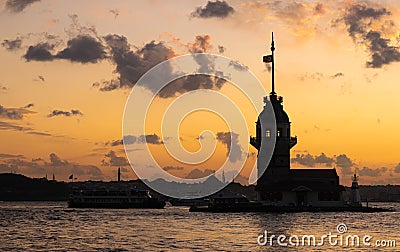 Cityscape of historic Istanbul with the silhouette of famous Maiden`s/Leander`s Tower with cruising ferryboats during the sunset Stock Photo