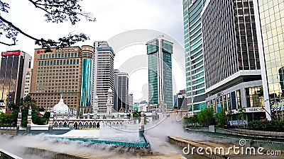 Cityscape of Kuala Lumpur. A beautiful white mosque among modern buildings. Multi cultural city of Asia Editorial Stock Photo