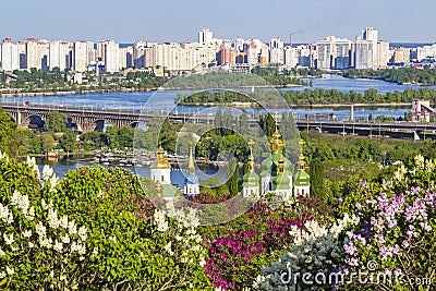 Cityscape of Kyiv with lilac blossom in spring Stock Photo