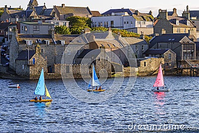 Cityscape in Lerwick with colorful sailboats in the water Stock Photo