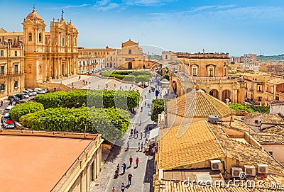 Cityscape of Noto. View of the central street with walking tourists. Province of Syracuse, Sicily, Italy Stock Photo